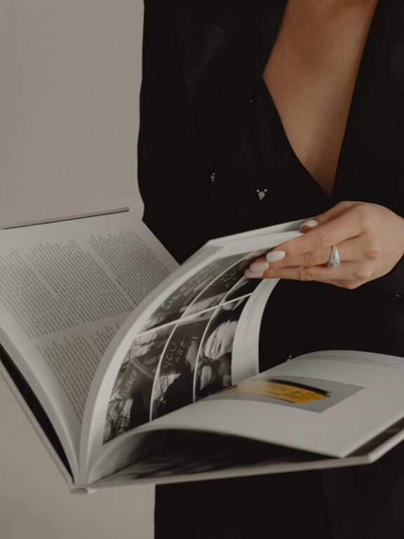 A woman is reading a magazine with her ring.